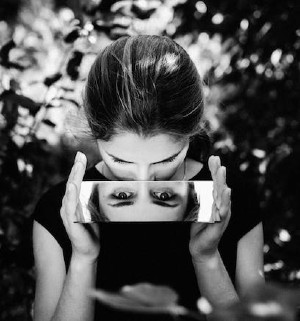 photo of girl looking into a mirror